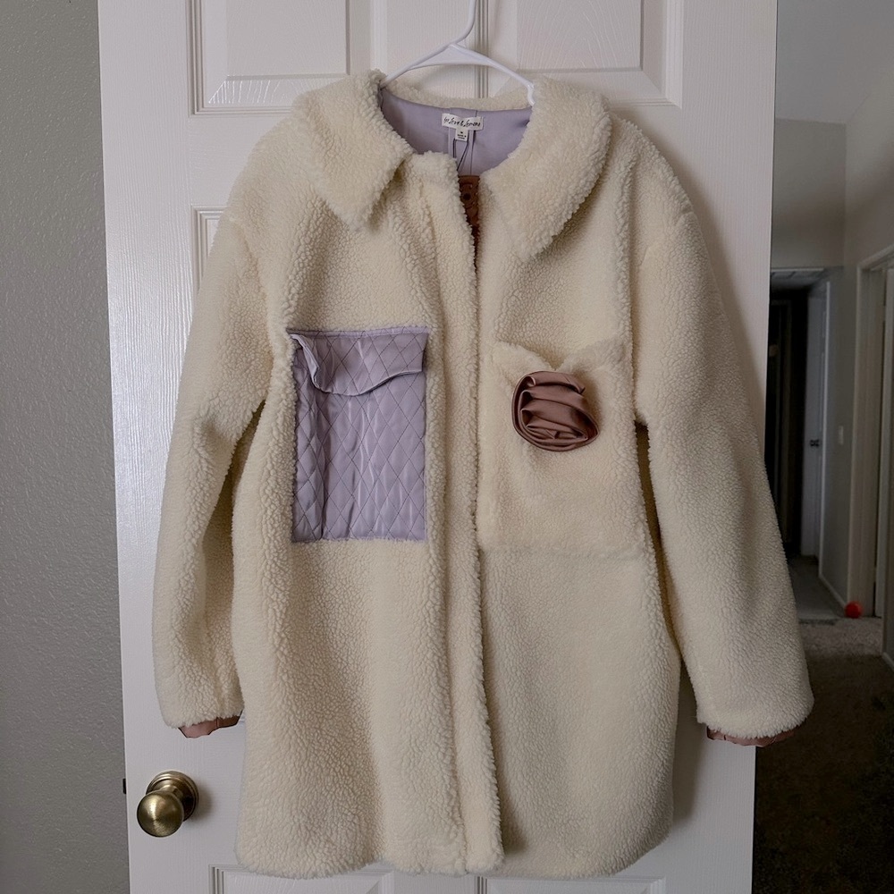 Cream Sherpa coat with lavender accents